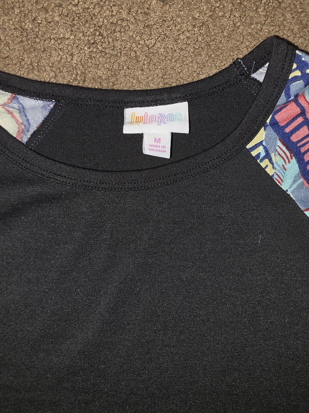 LuLaRoe Black Top with Multicolor Patterned Raglan Sleeves